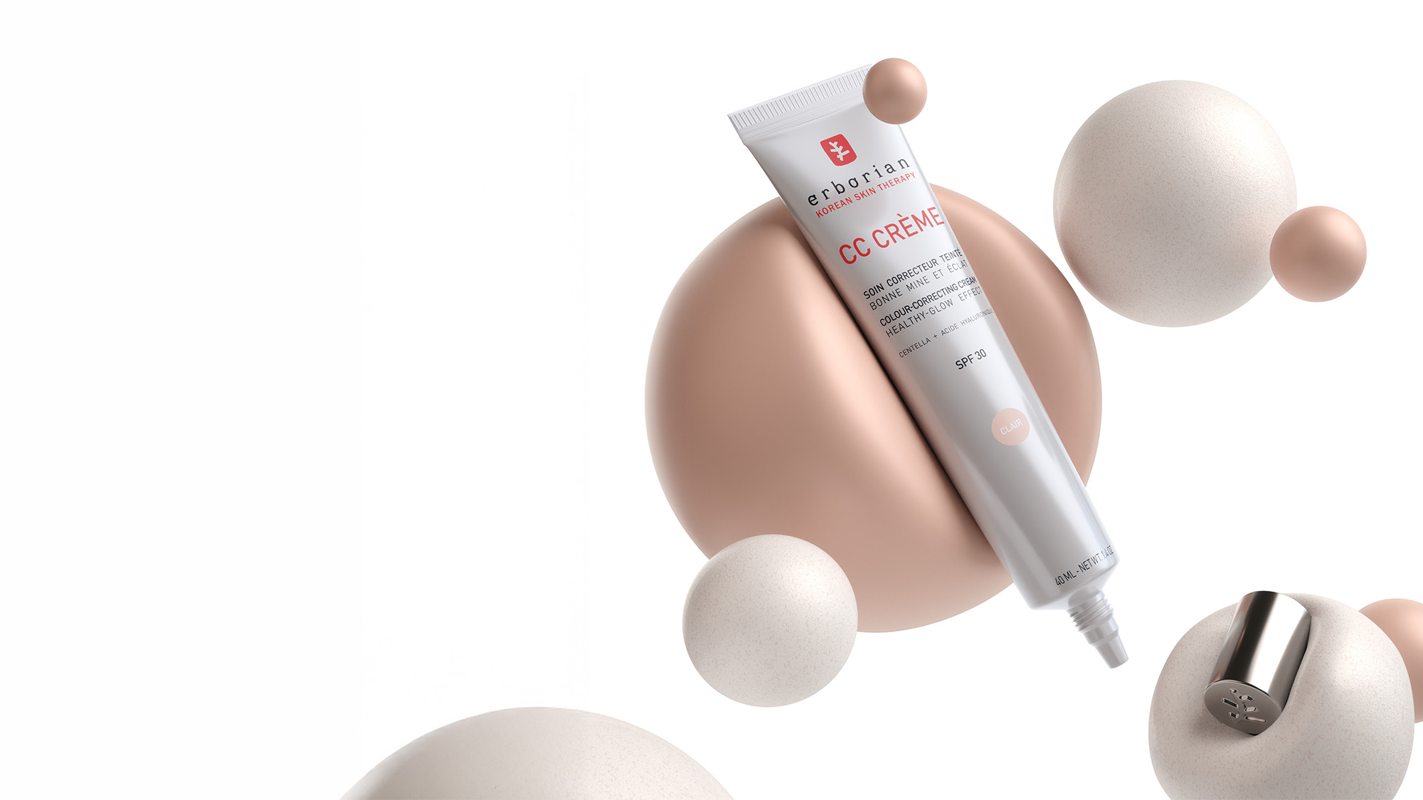 A tube of CC cream is surrounded by spheres in a minimalist setting.