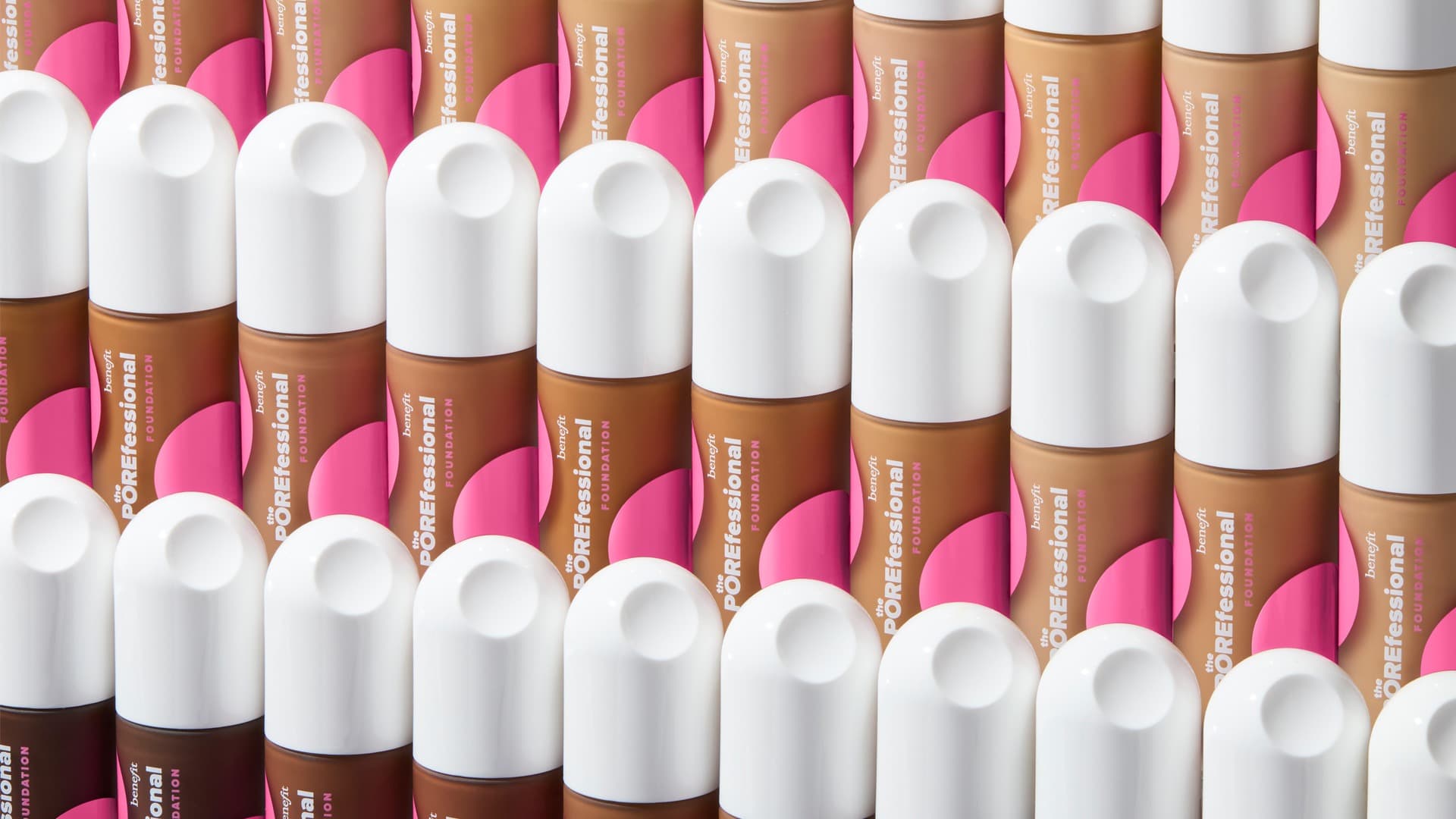 Rows of cosmetic bottles with white caps in various shades, arranged in a neat pattern against a pink background.