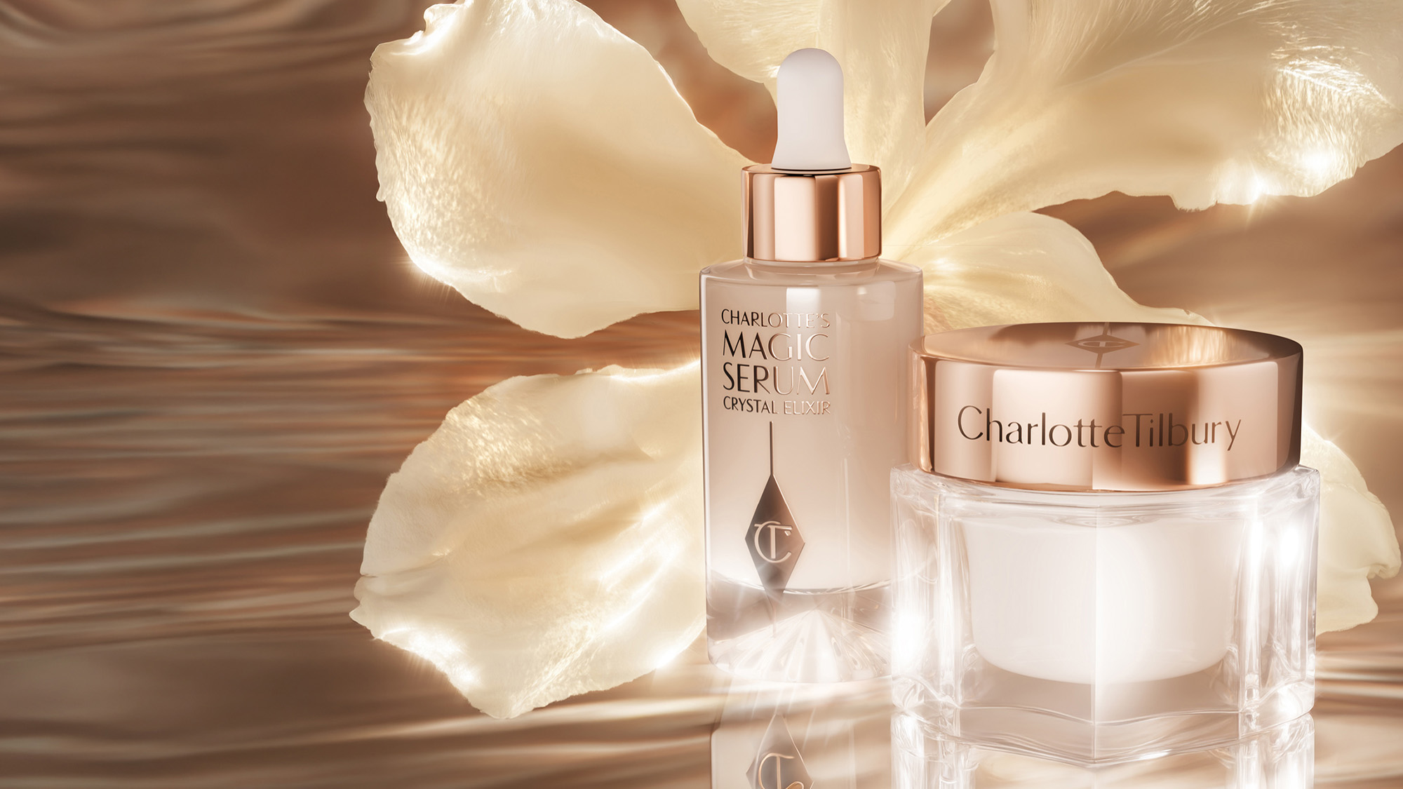 Charlotte Tilbury skincare products, including a serum and cream, are displayed against a soft, floral background.