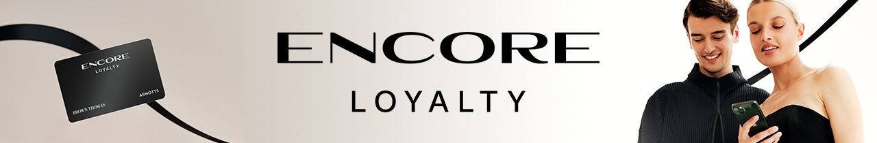 A couple looks at a phone beside a black card. Text reads 'ENCORE LOYALTY.'