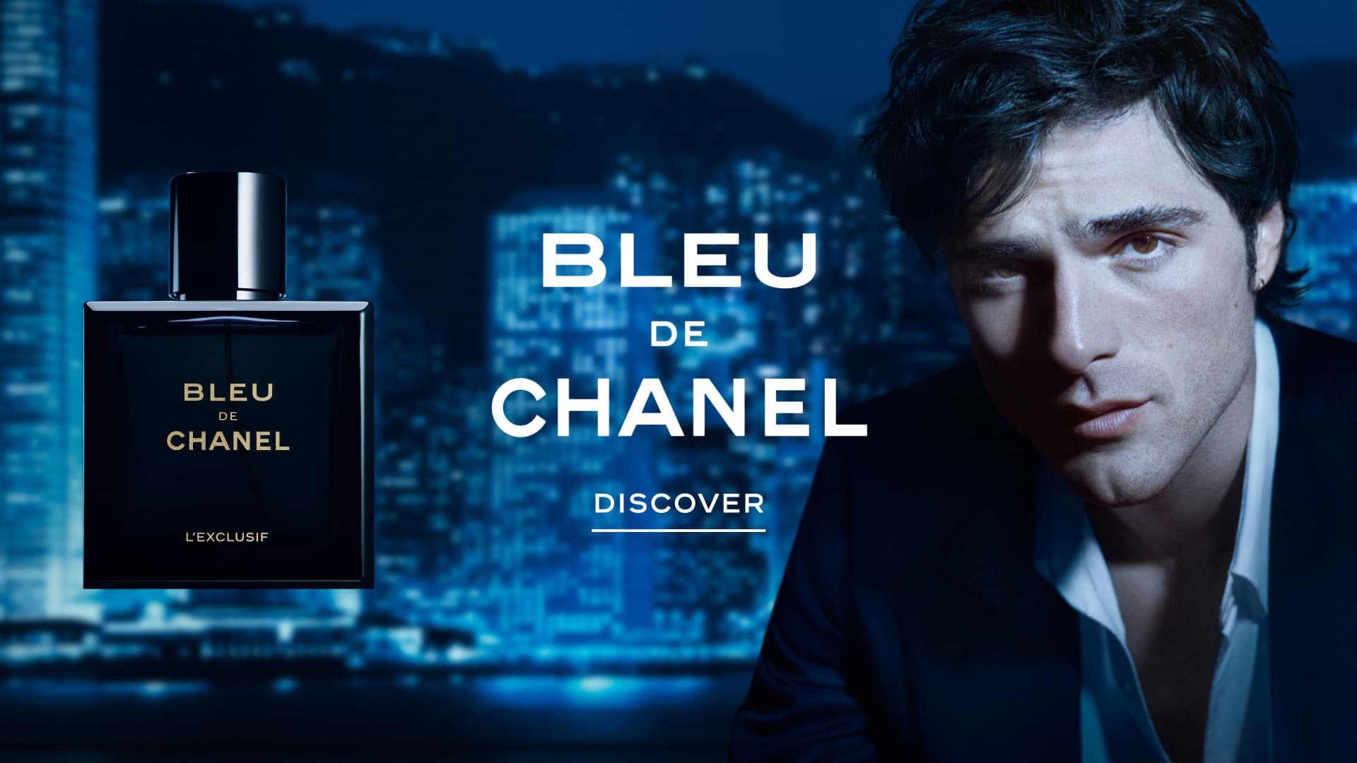 Bleu de Chanel fragrance bottle displayed against a cityscape at night, with a man in profile wearing a white shirt