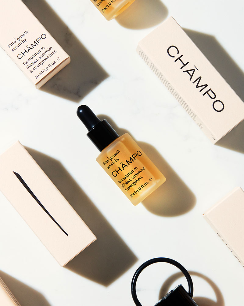 
Flat lay of CHAMPO hair serums and packaging on a white background.



