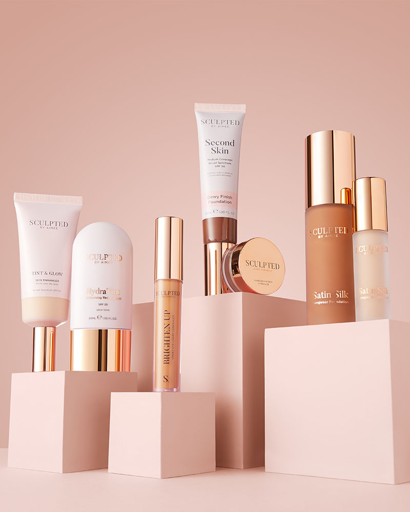 
Assorted Sculpted cosmetics arranged on pink blocks against a matching background.



