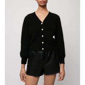Model wearing Maje Mistral Jewel Button Cardigan in black with jewel buttons, styled with black satin shorts