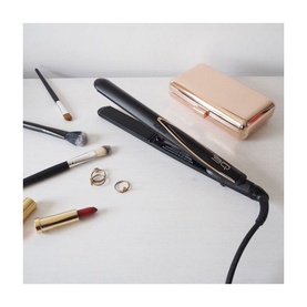 BaByliss 3Q Hair Straightener in black with rose gold accents, styled with makeup brushes, lipstick, rings and a rose gold clutch