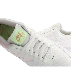 Nike Air Force 1 07 Trainers in white with pastel green insole, pink swoosh detail, white laces and sole, close-up view