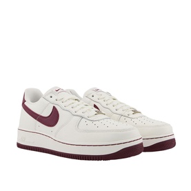 Nike Air Force 1 07 Trainers in white with deep red Swoosh branding, low-top silhouette, chunky rubber sole, and lace fastening