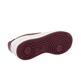 Nike Air Force 1 07 Trainers in white, showing burgundy rubber sole with circular tread pattern and embossed Nike branding