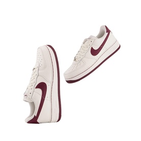 Nike Air Force 1 07 Trainers in white with burgundy swoosh branding, low top, chunky rubber sole, lace fastening, two pairs shown