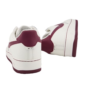 Nike Air Force 1 07 Trainers in white with burgundy heel panel, Swoosh branding, and chunky white rubber sole, rear view