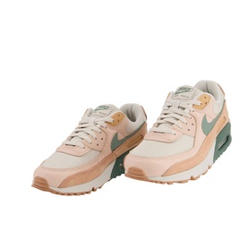 Nike Air Max 90 Trainers in beige with sage green swoosh, peach overlays, gum sole, and white midsole, pair angled view
