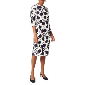 Model wearing Hobbs Aleena Floral Dress in cream with navy floral print, three-quarter sleeves, crew neck. Styled with navy heels