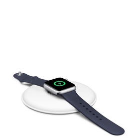 Apple Watch Magnetic Charging Dock in white, shown with Apple Watch with midnight sport band resting flat on dock, charging indicator visible