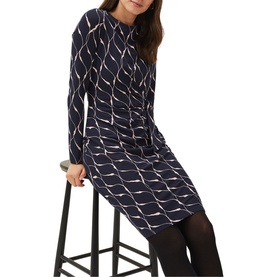 Model wearing Phase Eight Ally Print Dress in blue geometric print, long sleeve, round neck, knee length, with black tights