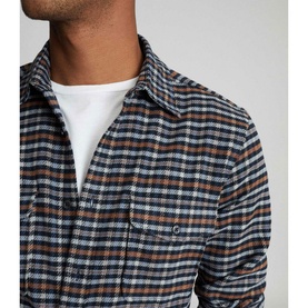 Model wearing Reiss Ash Overshirt in blue multi check, layered over a white crew-neck tee, close-up chest detail view