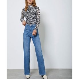 Model wearing Mint Velvet Animal Mesh Polo Neck Top in blue, styled with wide-leg mid-blue jeans