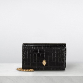 Alexander McQueen Skull Clutch Bag in black croc-embossed leather with gold skull clasp and chunky gold chain strap
