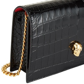 Alexander McQueen Skull Clutch Bag in black croc-embossed leather with gold skull clasp and gold chain strap, red interior visible