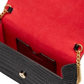 Alexander McQueen Skull Clutch Bag in black croc-embossed leather, open view revealing red suede interior with gold chain strap