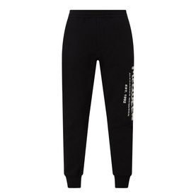 Alexander McQueen Graffiti Logo Sweatpants in black with white graphic logo print on left leg and ribbed cuffs