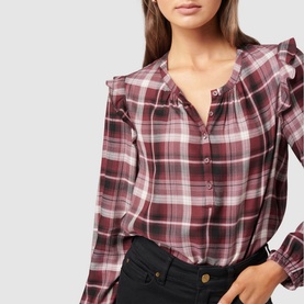 Model wearing Forever New Amy Checked Frill Shoulder Blouse in burgundy plaid, styled with black jeans. Frill shoulders and button placket visible
