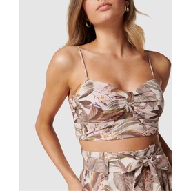 Model wearing Forever New Amena Crop Bustier Co-ord Top in pink floral print with spaghetti straps, styled with matching tie-waist skirt
