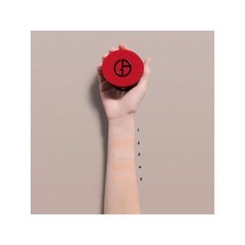 Armani Beauty To Go Cushion Refill in red compact case, held by model showing shade swatches on wrist