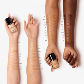 Armani Beauty Luminous Silk Foundation shade swatches shown across three arms in light, medium, and deep skin tones with numbered shades