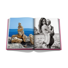 Assouline Ibiza Bohemia hardbound book open showing black and white beach photography and coastal rock stack imagery