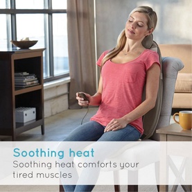 Homedics Shiatsu Pro Back Massage Chair in use, woman seated in armchair with massager on back, holding remote control