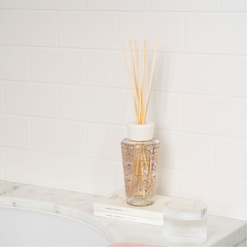 BAOBAB My First Baobab Paris Diffuser 250ml, clear glass bottle with gold detailing, white cap and natural reed sticks, styled on marble bath edge
