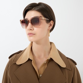 Model with Burberry BE4345 Square Sunglasses in brown acetate with gradient lenses, styled with gold earrings and a trench coat