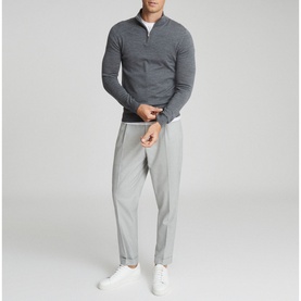 Model wearing Reiss Blackhall Funnel Neck Sweater in grey, styled with light grey trousers and white trainers