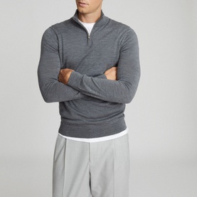 Model wearing Reiss Blackhall Funnel Neck Sweater in grey with quarter-zip detail, styled with light grey trousers and white T-shirt