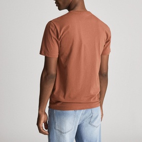 Model wearing Reiss Bless Regular Fit T-Shirt in brown, round neck, short sleeves, styled with light blue jeans. Back view