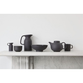Royal Doulton Olio Black Serving Bowl 21cm styled with matching black matte teapot, jug, mugs, and cup on marble surface