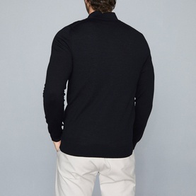 Model wearing Reiss Blackhall Funnel Neck Sweater in blue, rear view, styled with white trousers