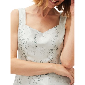 Model wearing Phase Eight Becka Trailing Jacquard Dress in green, sleeveless with sweetheart neckline and floral jacquard print, close-up detail shot