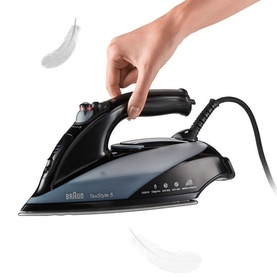 Braun TexStyle 5 Steam Iron in black, shown being held by hand with steam vents visible on sole plate
