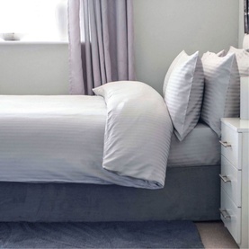 Belledorm Hotel Suite Platinum Fitted Sheet in metallic, 540 thread count sateen cotton, styled on a double bed with matching pillowcases