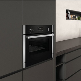 Neff 36 Litre Built-In Combi Microwave with Steam Function in silver, installed in dark grey fitted kitchen cabinetry with digital display panel
