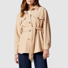 Model wearing Forever New Rosie Belted Shacket in brown, styled with blue jeans. Features chest pockets and gold-tone buttons