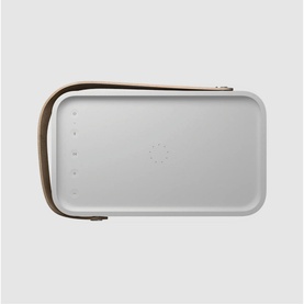 Bang & Olufsen Beolit 20 portable speaker in grey, top-down view showing flat surface with tan leather carry handle