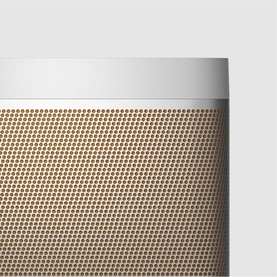 Bang & Olufsen Beolit 20 portable speaker in grey, close-up of gold perforated grille with white top edge detail