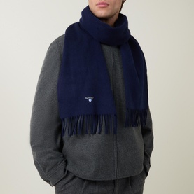 Model with Barbour Lambswool Scarf in navy, featuring fringed ends, draped over grey coat
