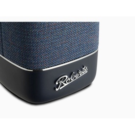 Roberts Beacon 320 Bluetooth Speaker in blue, close-up showing woven fabric body, black base, and silver Roberts logo badge