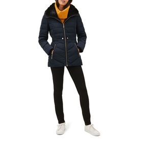 Model wearing Phase Eight Bobbie Short Puffer Coat in blue with detachable faux fur collar, styled with black trousers and white trainers