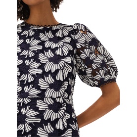 Model wearing Phase Eight Caitlyn Guipre Lace Dress in blue, featuring floral lace detailing and short puff sleeves with round neckline