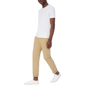 Model wearing Boss Black Casual Tiburt 55 T-Shirt in white, styled with tan jogger trousers and white trainers