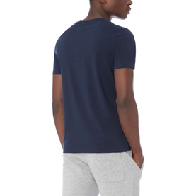 Model wearing Boss Black Casual 55 Tiburt Crew Neck T-Shirt in navy, rear view, styled with light grey joggers